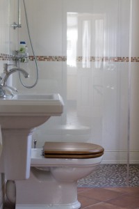 Gästebad mit ebenerdiger Dusche im mediterranen Landhausstil
